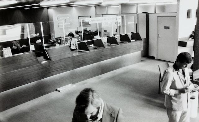 a black and white photo of the inside of a bank