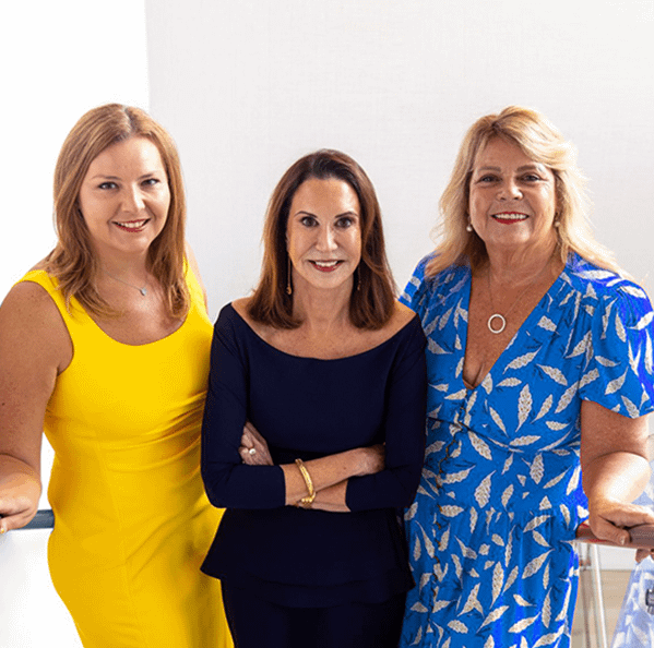 three professional looking women posing for a photo together