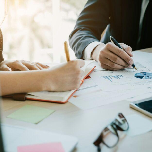 two people looking over paperwork
